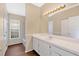 Well-lit bathroom featuring a large vanity, sink, and a window for natural light at 11223 Huxley Ave, Orlando, FL 32837
