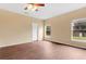 Spacious bedroom featuring wood floors, ceiling fan, and natural light from two windows at 11223 Huxley Ave, Orlando, FL 32837