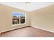 Bedroom with hardwood floors and a window overlooking the yard at 11223 Huxley Ave, Orlando, FL 32837