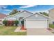 Charming one-story home with well-maintained landscaping and a two-car garage at 11223 Huxley Ave, Orlando, FL 32837