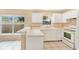 Bright kitchen with white appliances and ample counter space, perfect for cooking at 11223 Huxley Ave, Orlando, FL 32837