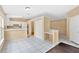 Open kitchen with white cabinetry and breakfast bar overlooking the dining area at 11223 Huxley Ave, Orlando, FL 32837