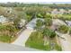 Aerial view of a home with mature palm trees, a driveway, and well-maintained lawn at 116 Douglas St, Edgewater, FL 32141