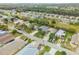 An aerial view shows the home situated in a quiet neighborhood with lush greenery and a view of a boat parked in the driveway at 116 Douglas St, Edgewater, FL 32141