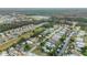 An aerial view shows a mix of waterfront and residential homes in a scenic area with canals, boat docks, and mature trees at 116 Douglas St, Edgewater, FL 32141