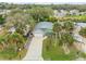 Aerial view of a home showcasing its well-manicured lawn and lush palm trees at 116 Douglas St, Edgewater, FL 32141