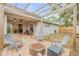 Charming backyard with a covered patio, fire pit, and ample seating at 116 Douglas St, Edgewater, FL 32141