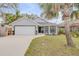 Charming single-story home featuring a well-maintained lawn, two-car garage, and inviting front entrance at 116 Douglas St, Edgewater, FL 32141