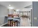 Open kitchen showcases sleek white cabinets, a breakfast bar, and an airy dining area with tiled flooring at 116 Douglas St, Edgewater, FL 32141
