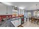 Bright kitchen features white cabinets, red backsplash, and stainless steel appliances with an adjacent dining area at 116 Douglas St, Edgewater, FL 32141