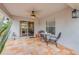 Cozy covered patio featuring tiled floors, a ceiling fan, and an outdoor dining set at 116 Douglas St, Edgewater, FL 32141