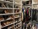 Organized walk-in closet featuring custom shelving and hanging rods for optimal storage at 12059 Uleta Ln, Orlando, FL 32827