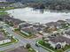 Highlighted aerial view shows property lines of the house in a neighborhood near a pond at 1380 Patterson Ter, Lake Mary, FL 32746