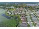 An aerial view of a lakeside community featuring modern homes, pools, and lush aquatic vegetation at 1380 Patterson Ter, Lake Mary, FL 32746