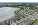 An aerial view captures homes nestled alongside a serene lake, enhanced by lush landscaping at 1380 Patterson Ter, Lake Mary, FL 32746