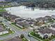 Aerial view of the neighborhood showcasing houses, streets, and a serene lake at 1380 Patterson Ter, Lake Mary, FL 32746