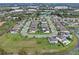 An aerial view of a residential community with water views and neatly arranged homes and red-outlined property at 1380 Patterson Ter, Lake Mary, FL 32746