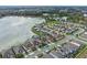 An aerial view captures homes nestled alongside a serene lake, enhanced by lush landscaping and red-outlined property at 1380 Patterson Ter, Lake Mary, FL 32746