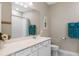 Bright bathroom with white cabinets, quartz countertop, framed mirror, and separate toilet room at 1380 Patterson Ter, Lake Mary, FL 32746