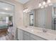 Bathroom featuring double sinks, bright lighting and a view to the bedroom at 1380 Patterson Ter, Lake Mary, FL 32746