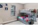 Charming ' bedroom with a gray bunk bed, themed bedding, and natural light from the window at 1380 Patterson Ter, Lake Mary, FL 32746