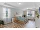 Calm bedroom features tray ceiling, natural light, and coordinated furniture at 1380 Patterson Ter, Lake Mary, FL 32746