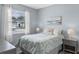 Comfortable bedroom with a queen-size bed, two side tables with lamps, and a large window at 1380 Patterson Ter, Lake Mary, FL 32746