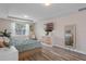 Bright bedroom with a cozy seating area and a view of the outdoors at 1380 Patterson Ter, Lake Mary, FL 32746