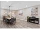Dining room featuring a long wooden table, pendant lighting, and modern decor at 1380 Patterson Ter, Lake Mary, FL 32746