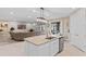 Modern kitchen with stainless steel appliances, granite island and access to the living area at 1380 Patterson Ter, Lake Mary, FL 32746