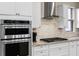 Kitchen featuring stainless steel appliances, modern white cabinetry, and granite countertops at 1380 Patterson Ter, Lake Mary, FL 32746