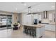 Eat-in kitchen with an island, stainless steel appliances, tile floors, and a sliding glass door at 1380 Patterson Ter, Lake Mary, FL 32746