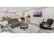 Bright living room featuring a gray sectional sofa, TV, and a decorative rug at 1380 Patterson Ter, Lake Mary, FL 32746