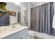 Bathroom showcasing a vanity with a sink, complemented by a shower with a gray curtain at 15373 Murcott Harvest Loop, Winter Garden, FL 34787