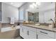 Bright bathroom with soaking tub, granite countertops, white cabinetry, and a separate glass shower at 15373 Murcott Harvest Loop, Winter Garden, FL 34787