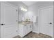 Bathroom featuring a granite countertop vanity and two doors at 15373 Murcott Harvest Loop, Winter Garden, FL 34787
