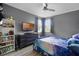 Bright bedroom with a Chelsea themed bed, dresser, TV, and ample natural light at 15373 Murcott Harvest Loop, Winter Garden, FL 34787