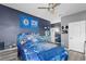 The bedroom features a cool sports theme, comfortable decor, and ample natural light at 15373 Murcott Harvest Loop, Winter Garden, FL 34787