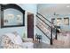 Bright foyer with stairway, chair and decorative mirror at 15373 Murcott Harvest Loop, Winter Garden, FL 34787