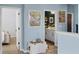 Bright hallway leading to a bedroom and bathroom, with stylish decor and ample natural light at 15373 Murcott Harvest Loop, Winter Garden, FL 34787