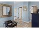 Hallway with light blue walls, multiple doorways, and a decorative mirror at 15373 Murcott Harvest Loop, Winter Garden, FL 34787