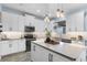 Bright kitchen with white cabinets, stainless steel appliances, and center island at 15373 Murcott Harvest Loop, Winter Garden, FL 34787