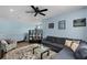 Inviting living room featuring a plush sectional, glass coffee table, and tasteful decor at 15373 Murcott Harvest Loop, Winter Garden, FL 34787