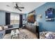 Well-lit living room with a large TV, comfortable seating, and stylish accents at 15373 Murcott Harvest Loop, Winter Garden, FL 34787