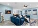 Inviting living room featuring a comfortable blue sectional, TV, and access to an outdoor patio at 15373 Murcott Harvest Loop, Winter Garden, FL 34787