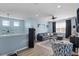 Upstairs living area with comfortable seating, modern lighting, and plenty of space at 15373 Murcott Harvest Loop, Winter Garden, FL 34787