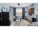Stylish living room with comfortable seating, ceiling fan, modern decor, and natural light at 15373 Murcott Harvest Loop, Winter Garden, FL 34787
