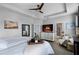 Bright main bedroom with a tray ceiling, fireplace, and ensuite bathroom at 15373 Murcott Harvest Loop, Winter Garden, FL 34787