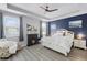 Relaxing main bedroom with a fireplace, tray ceiling, and ample natural light at 15373 Murcott Harvest Loop, Winter Garden, FL 34787