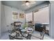 Cozy screened-in patio with a grill, dining area, and stylish decor at 15373 Murcott Harvest Loop, Winter Garden, FL 34787
